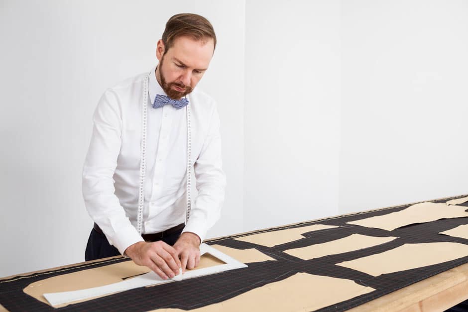 Bespoke tailor Egon Brandstetter constructing the pattern of a custom-tailored suit at his workshop in Berlin